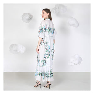 Woman wearing a floral dress against a white background